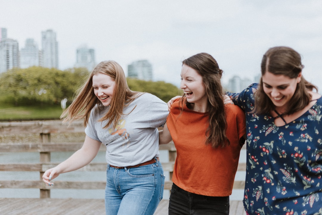 Is there a real test for IQ? by Free IQ Tests three women walking on brown wooden dock near high rise building during daytime